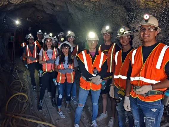 Students with mining gear at a mine tour 