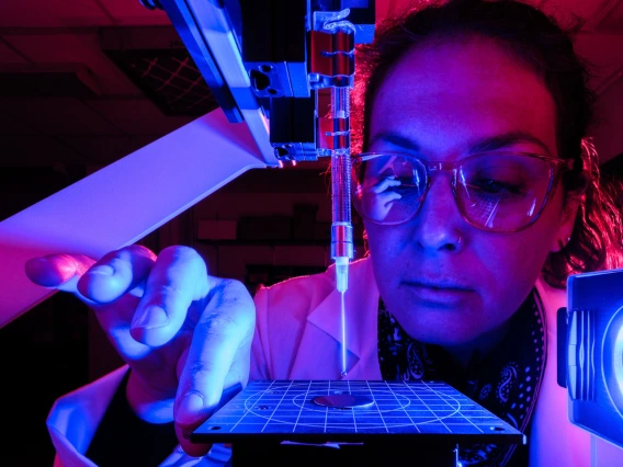 Scientist examining specimen under blue light