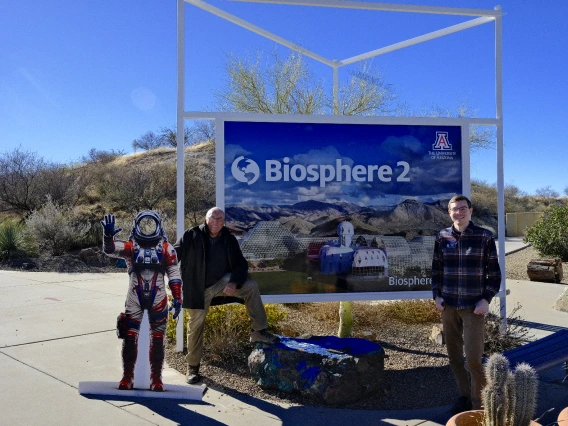 Tito and Joshua in front of the Biosphere banner