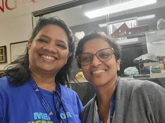 smiling teachers in front of gemstones