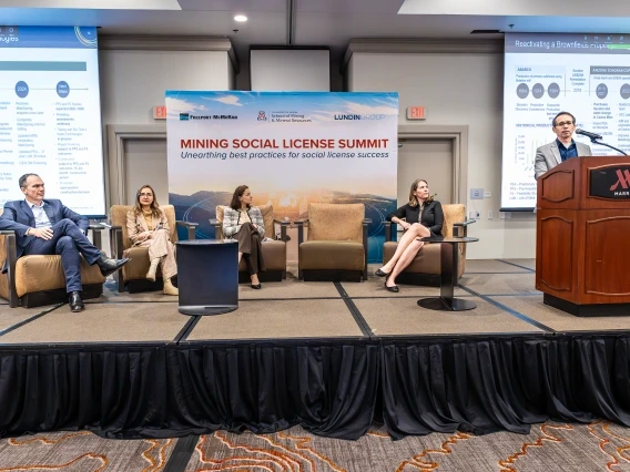 four panelists, seated and one person standing behind podium at UA Mining Social License Summit