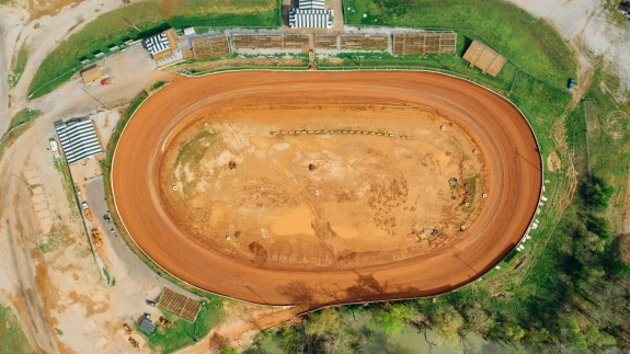 Drone view of bright open pit near growing trees