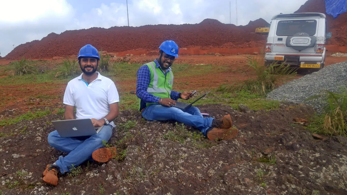 Two interns in the field