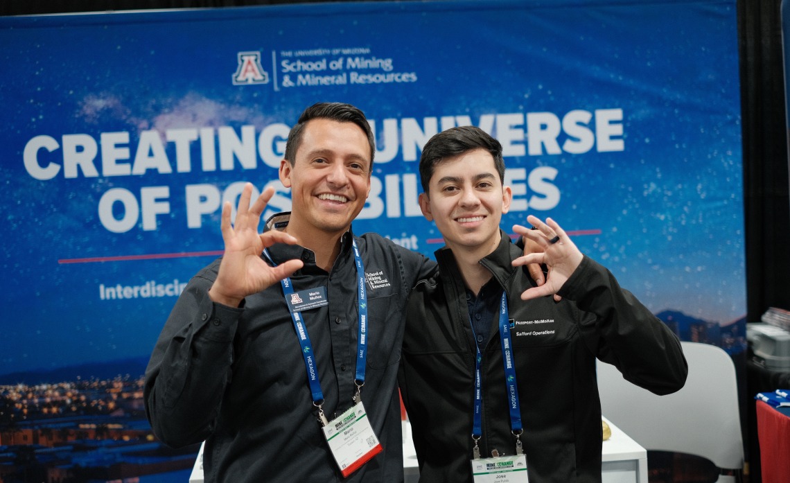 Mario Muñoz and grad researcher showcase Wildcat pride.