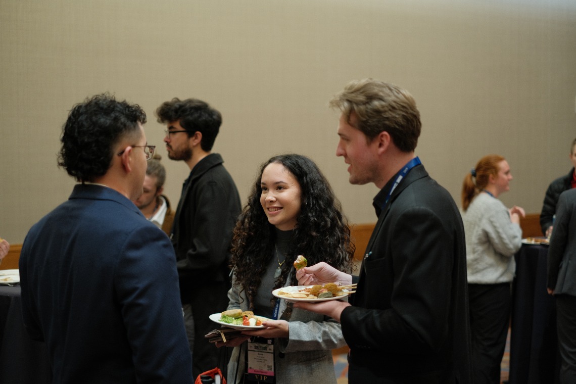 Students engage with each other at the alumni reception.