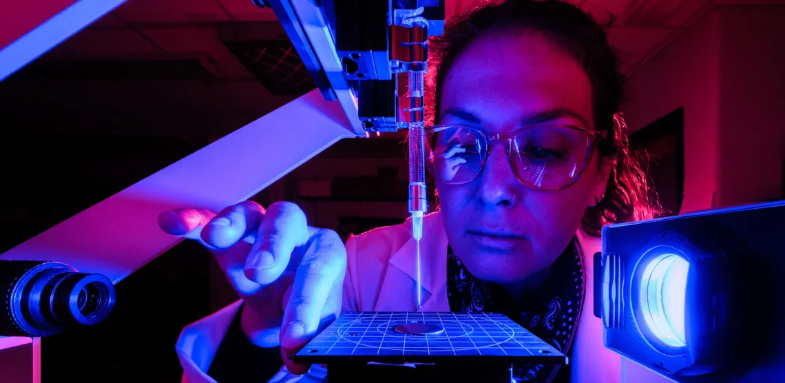 Scientist examining specimen under blue light