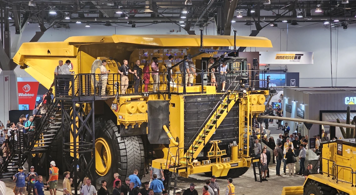 Big mining truck at MineExpo with visitors on top of it