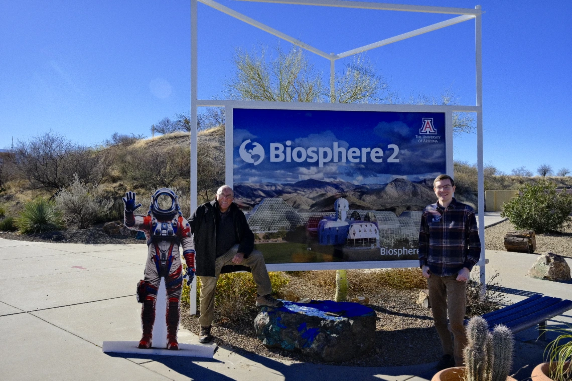 Tito and Joshua in front of the Biosphere banner