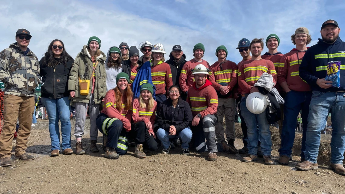 Alexis with a group of peers with mining gear