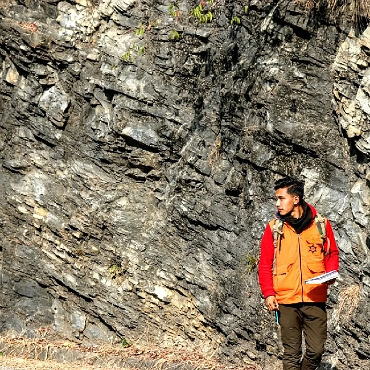 Biraj Lama in front of a mountain