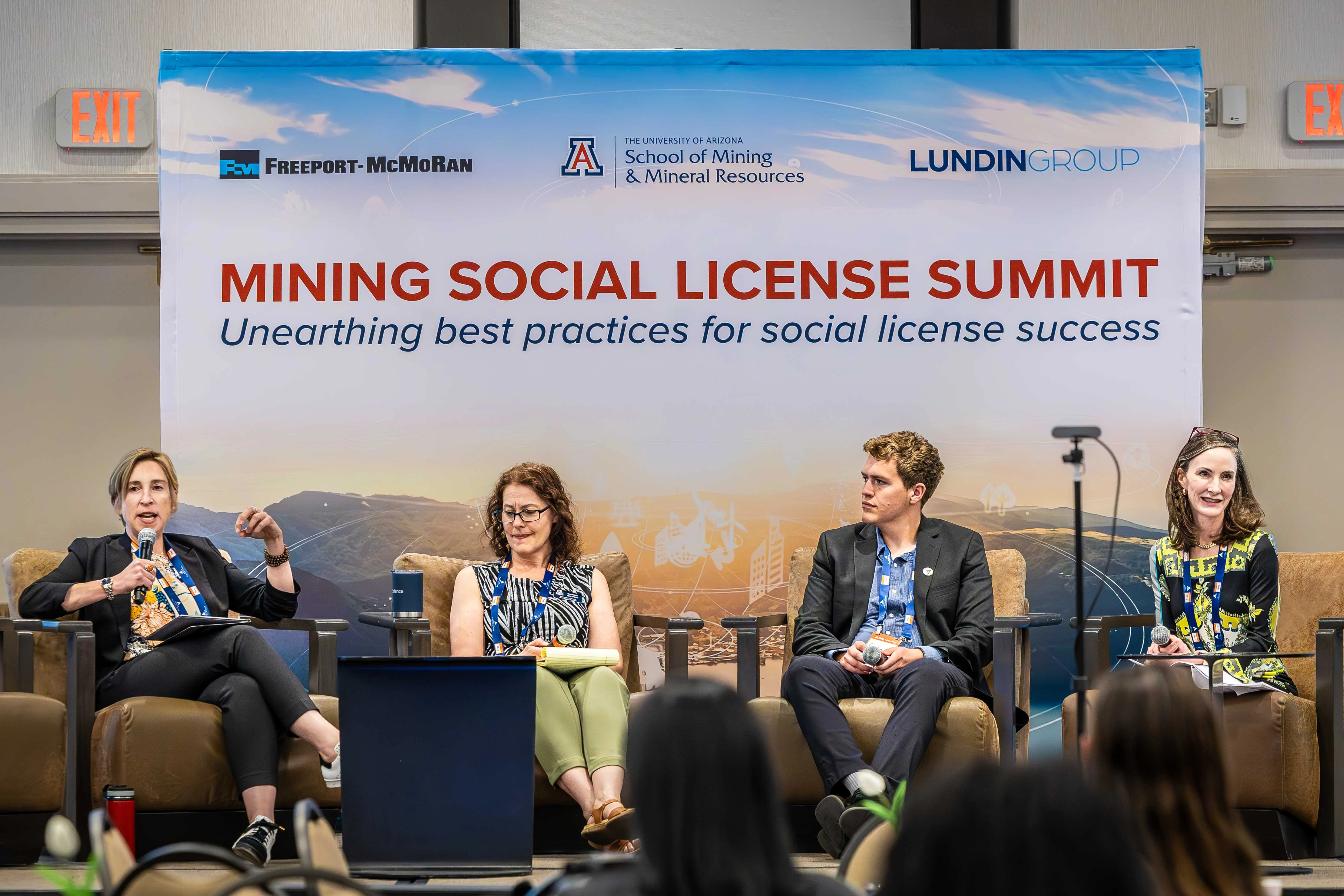 Four people on a stage at the Mining Social License Summit
