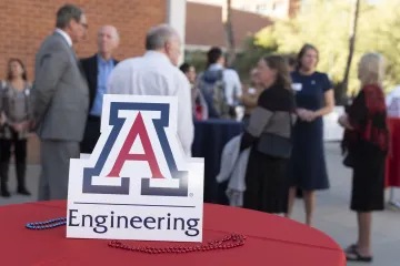 Image of engineering sign with Chalmers and University professors in the background