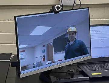 Grad researcher Carlos Olmos de Aguilera tests program's accuracy while wearing a helmet.