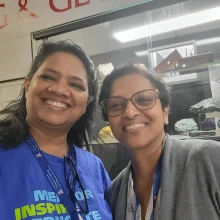 smiling teachers in front of gemstones